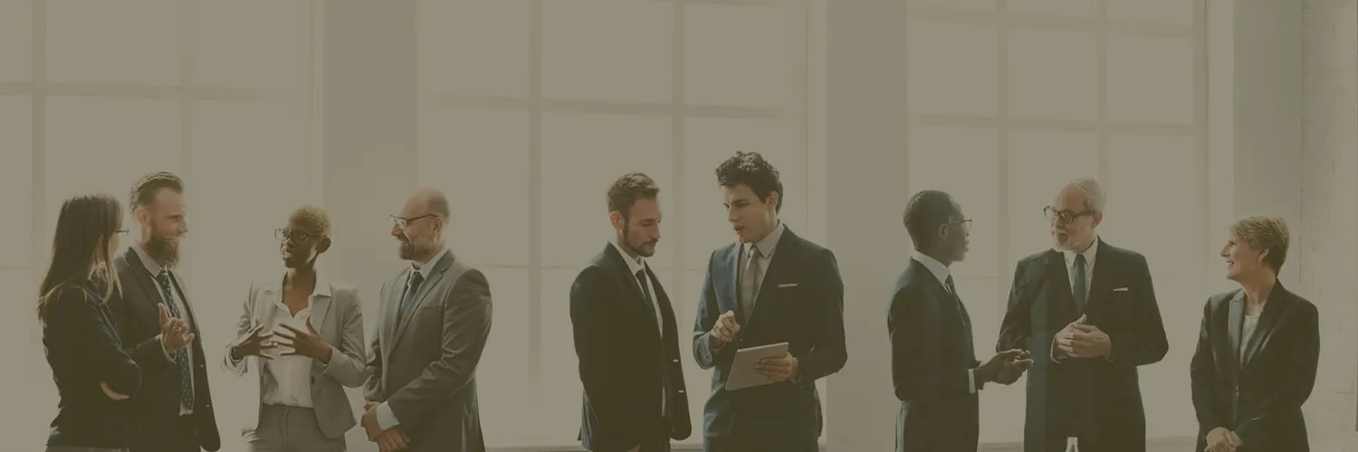 A group of attorneys and lawyers in a conference room discussing legal affairs.